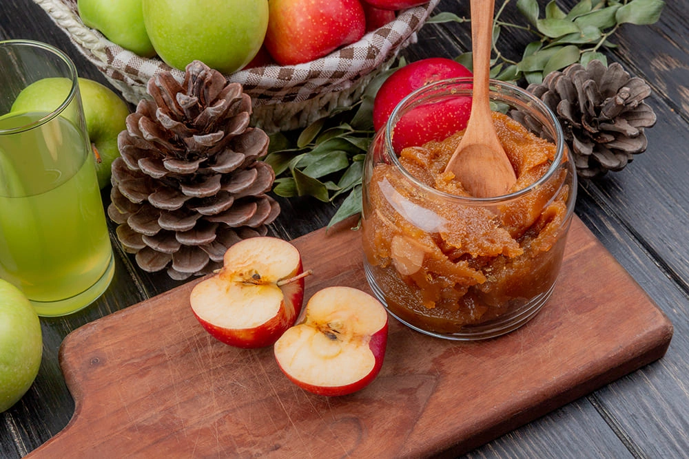 Green apple slices neatly arranged with a side of almond butter for dipping