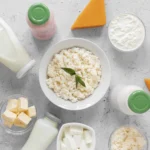An assortment of dairy products including cottage cheese, milk, butter, and various cheeses on a kitchen counter