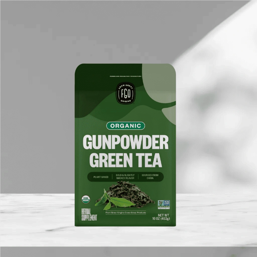 FGO Organic Gunpowder Green Tea in green packaging on a marble surface.