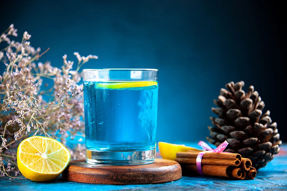Glass of blue flavored water with lemon slice