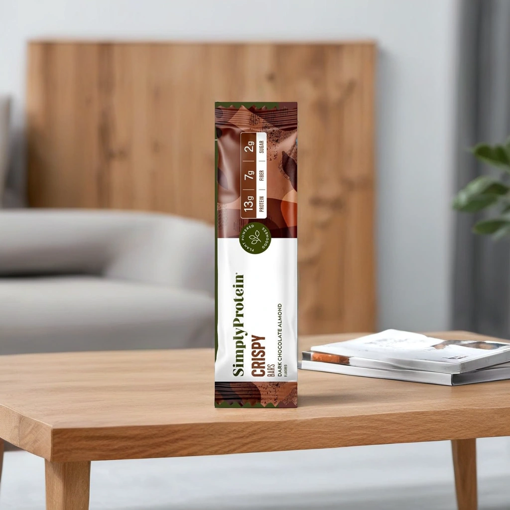 : SimplyProtein Crispy Bar in Dark Chocolate Almond flavor placed on a wooden table.